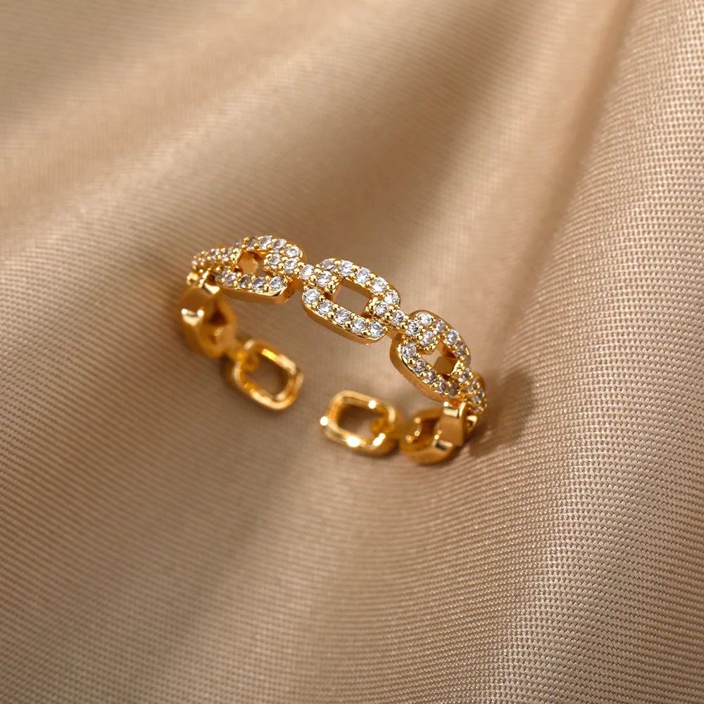 Anillo abierto de acero inoxidable con diseño trenzado y circonita
