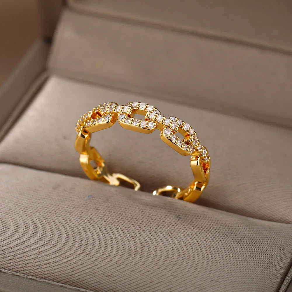 Anillo abierto de acero inoxidable con diseño trenzado y circonita