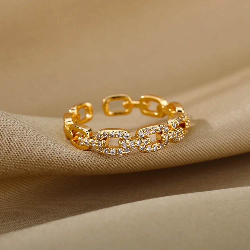 Anillo abierto de acero inoxidable con diseño trenzado y circonita
