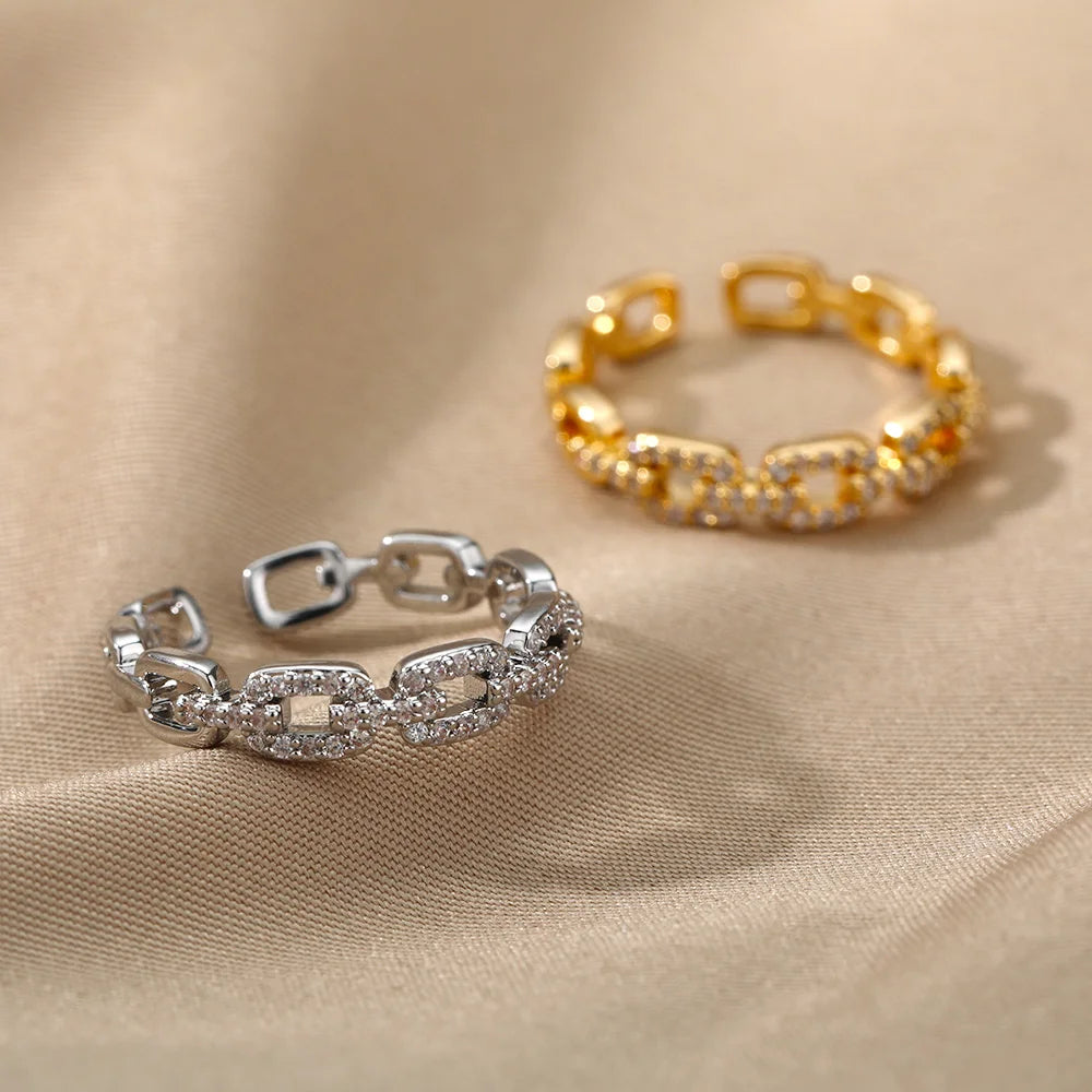 Anillo abierto de acero inoxidable con diseño trenzado y circonita
