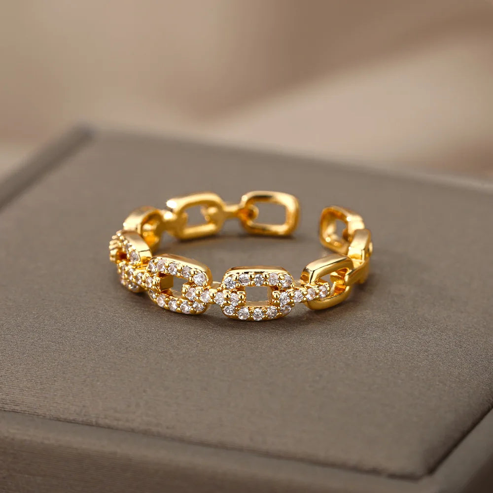 Anillo abierto de acero inoxidable con diseño trenzado y circonita