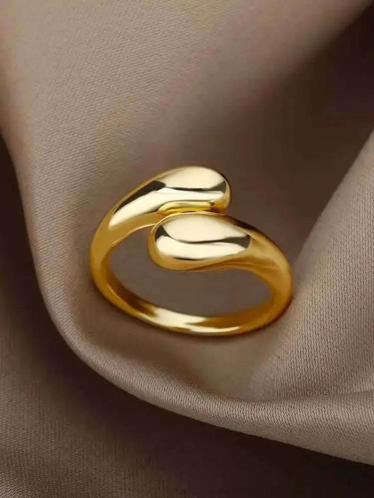 Anillo abierto de acero inoxidable dorado con doble bola geométrica