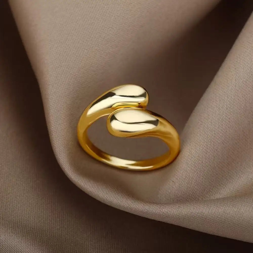 Anillo abierto de acero inoxidable dorado con doble bola geométrica