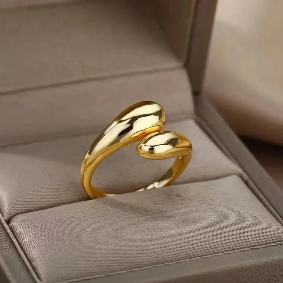 Anillo abierto de acero inoxidable dorado con doble bola geométrica